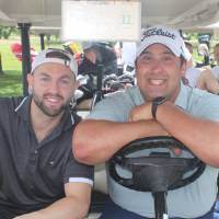 2 men in a golf cart